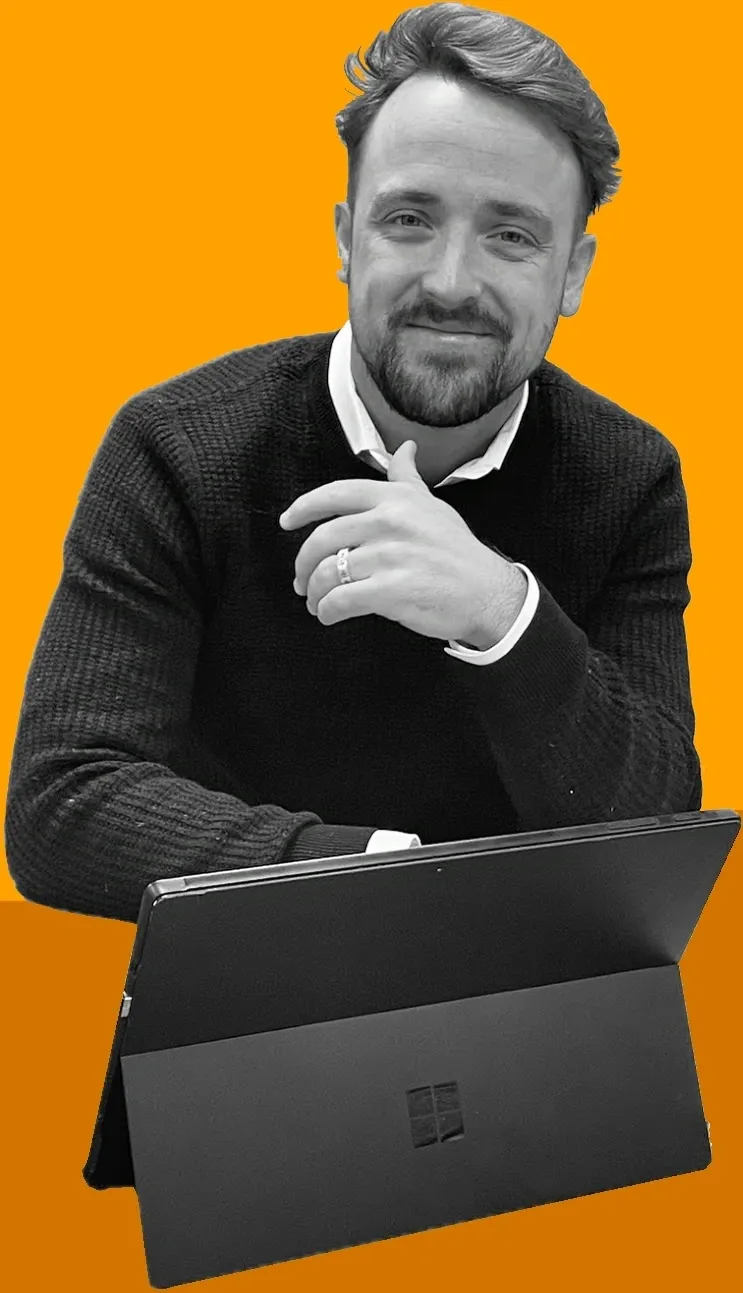 A man sitting at a table with his laptop.