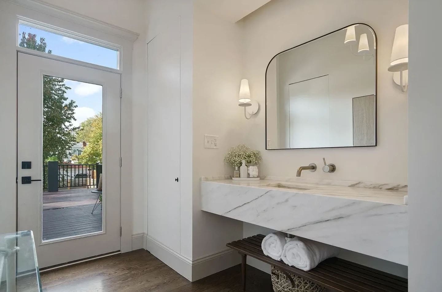 A bathroom with two sinks and a large mirror.