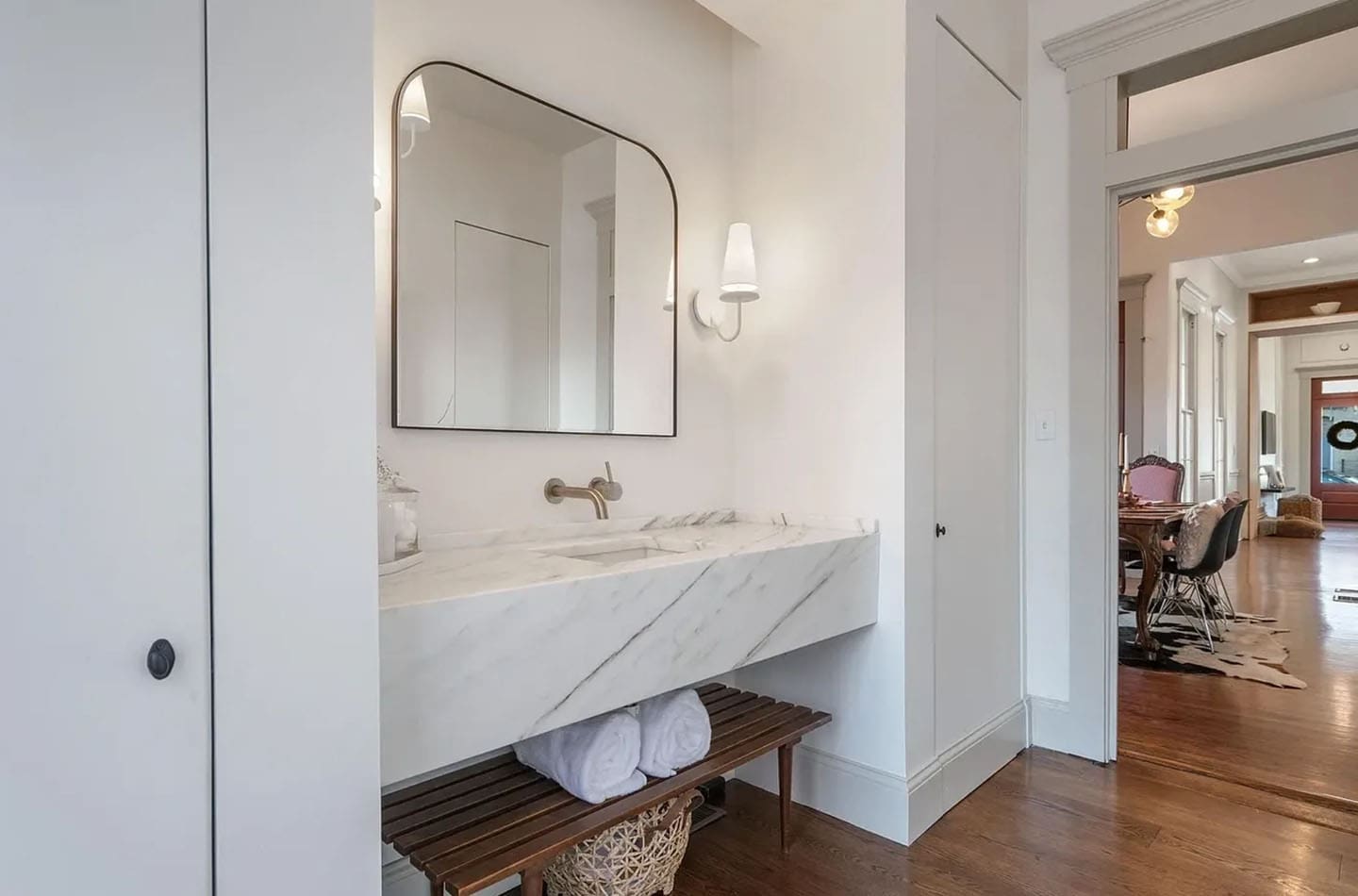 A bathroom with a large mirror and two sinks.