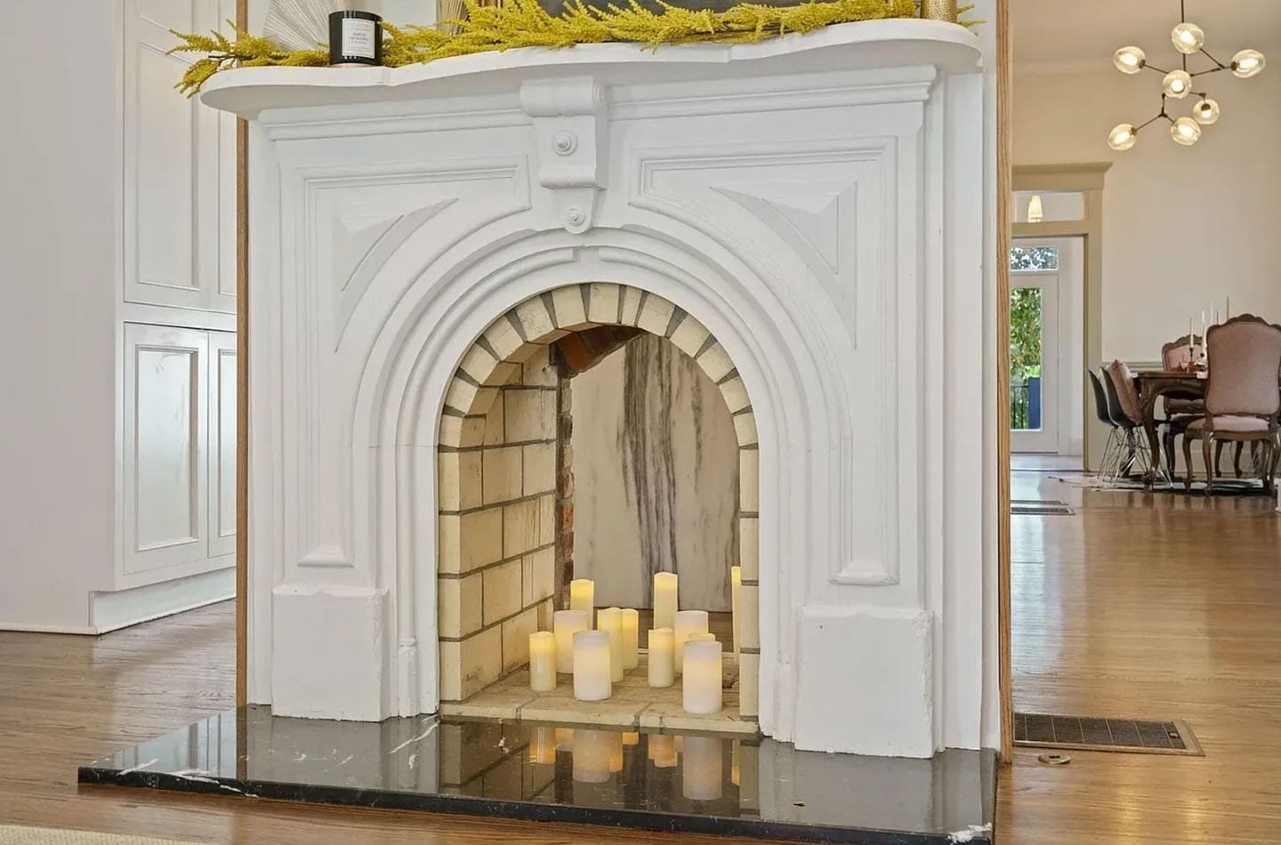 A fireplace with candles in it sitting on the floor.