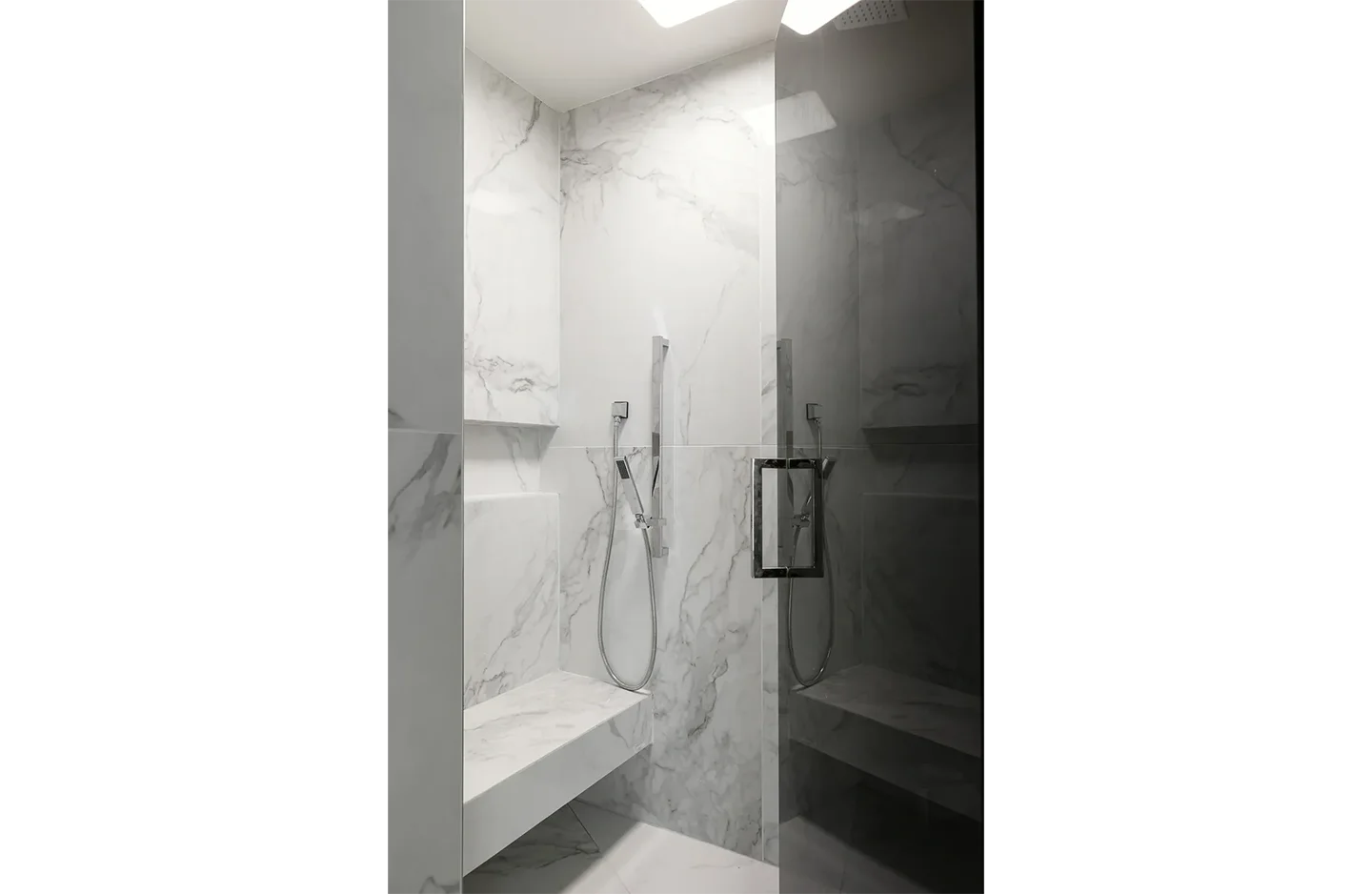 A bathroom with marble walls and floors