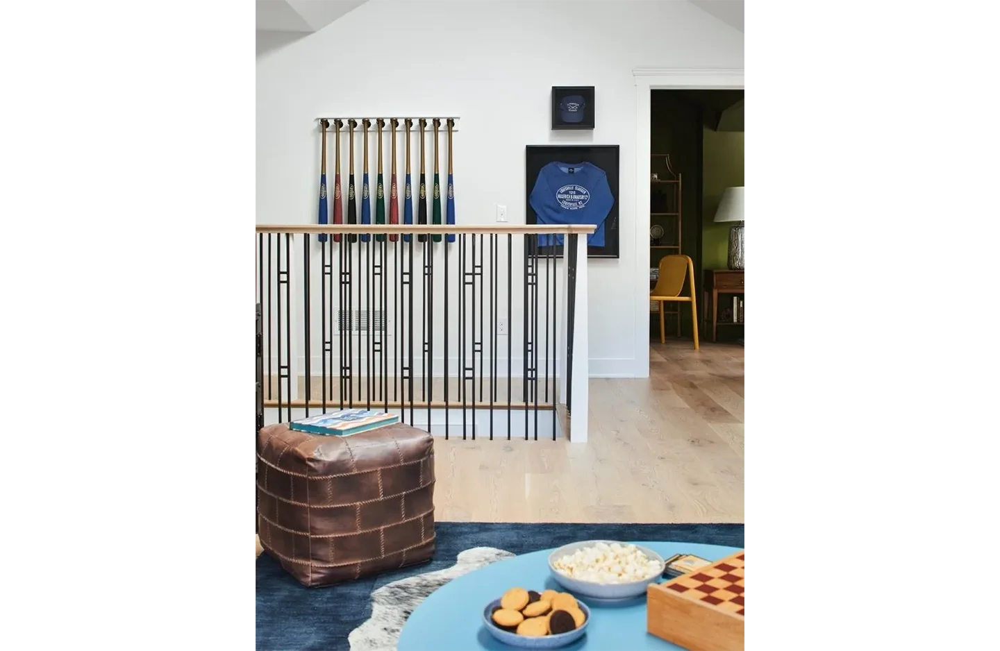 A room with a table and chairs, a chess board and a wall.