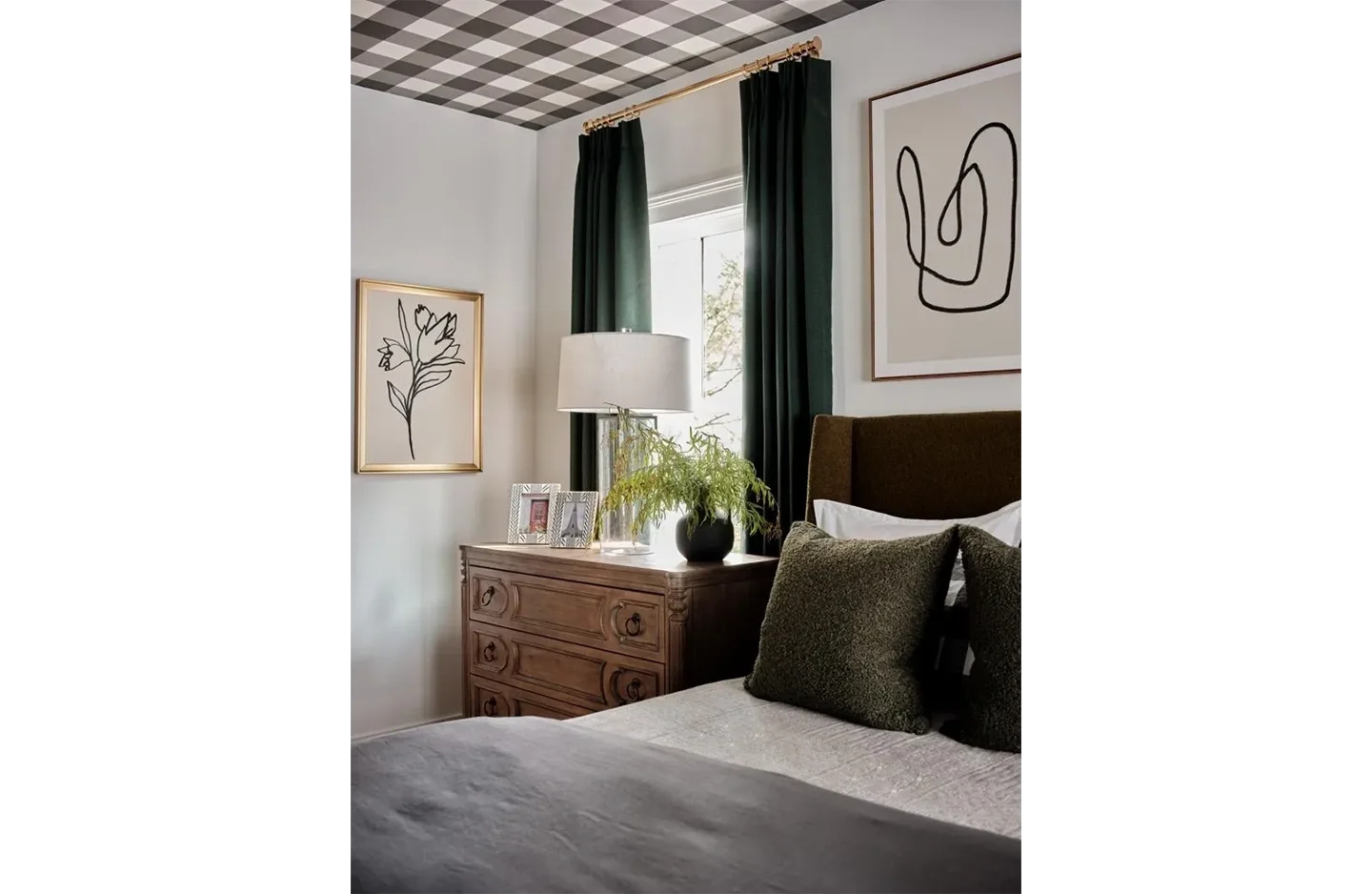 A bedroom with a bed, dresser and window.