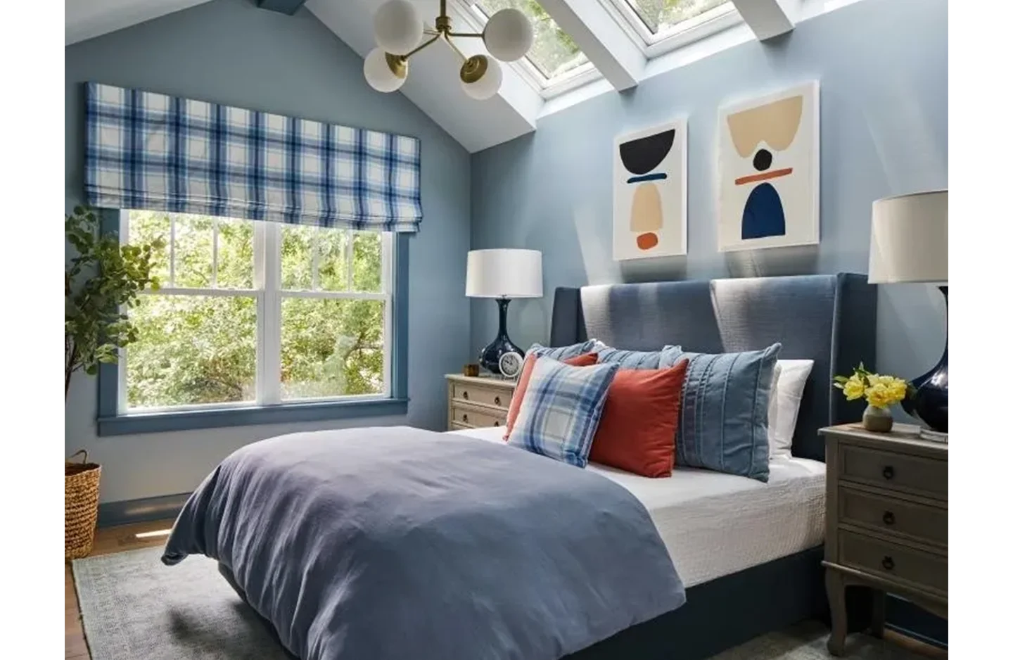 A bedroom with blue walls and a large bed.