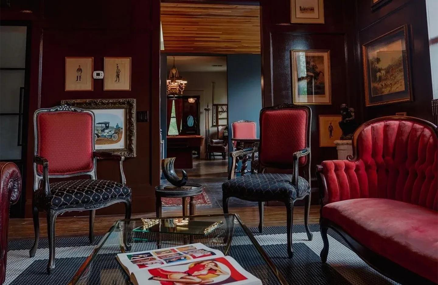 A living room filled with furniture and pictures on the wall.