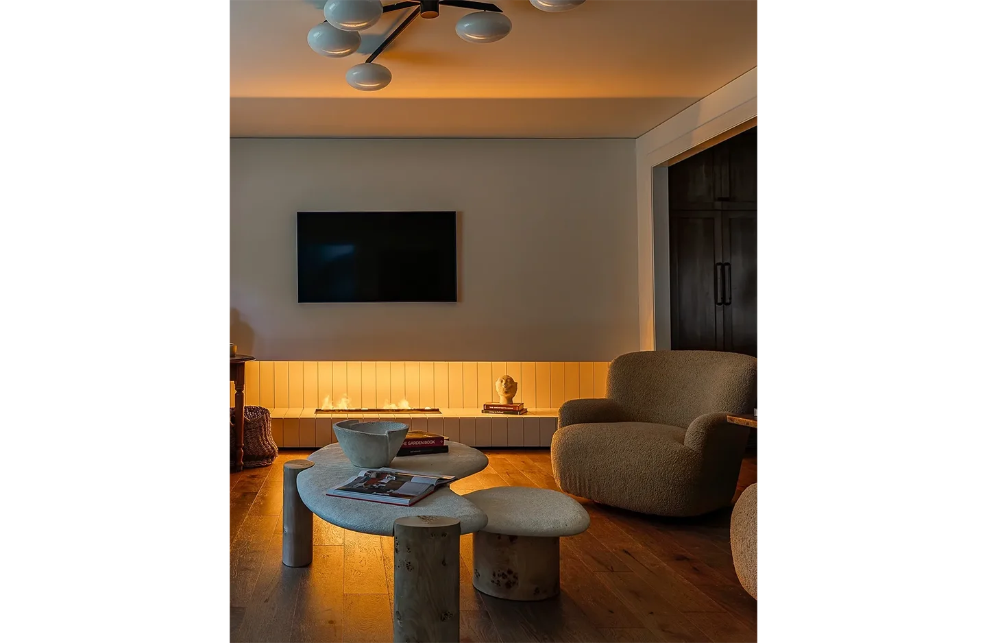 A living room with a couch, chairs and table.