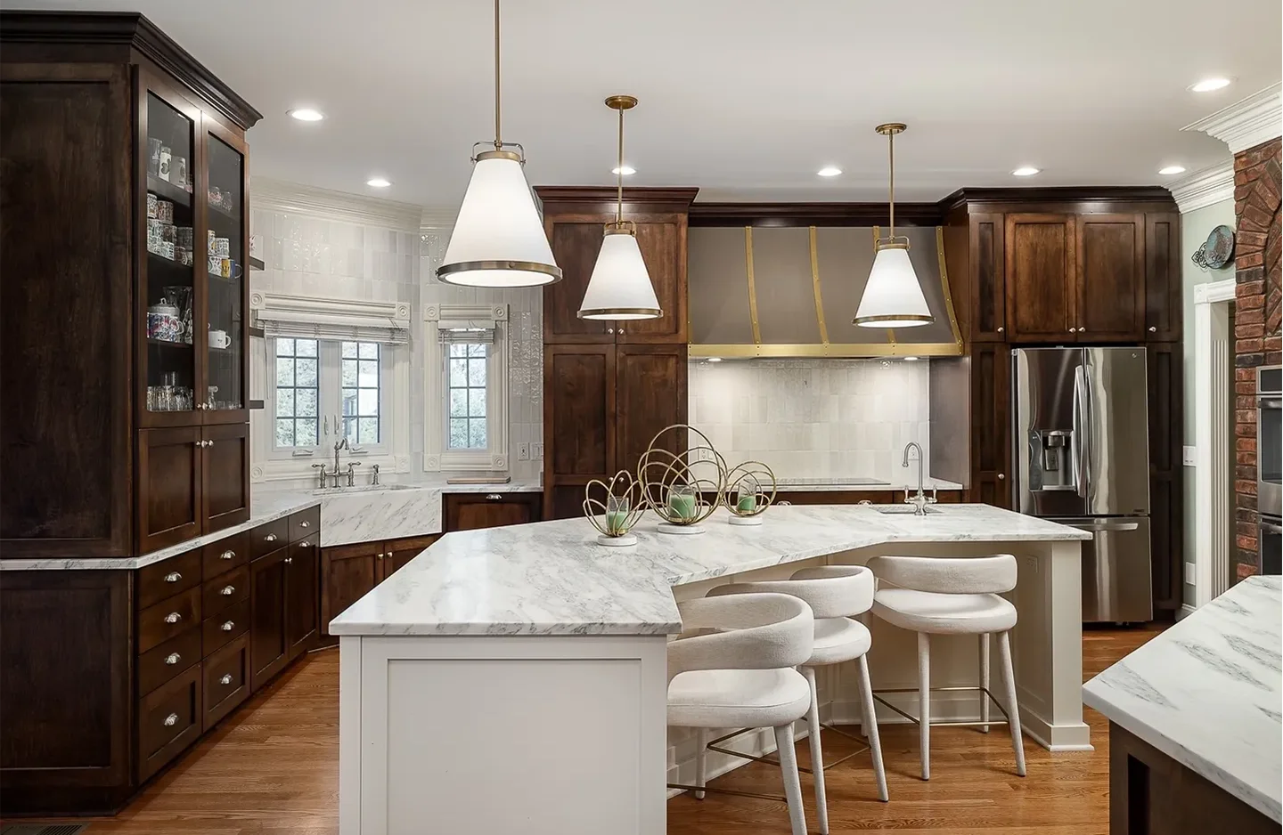 A kitchen with two large white counters and one island.