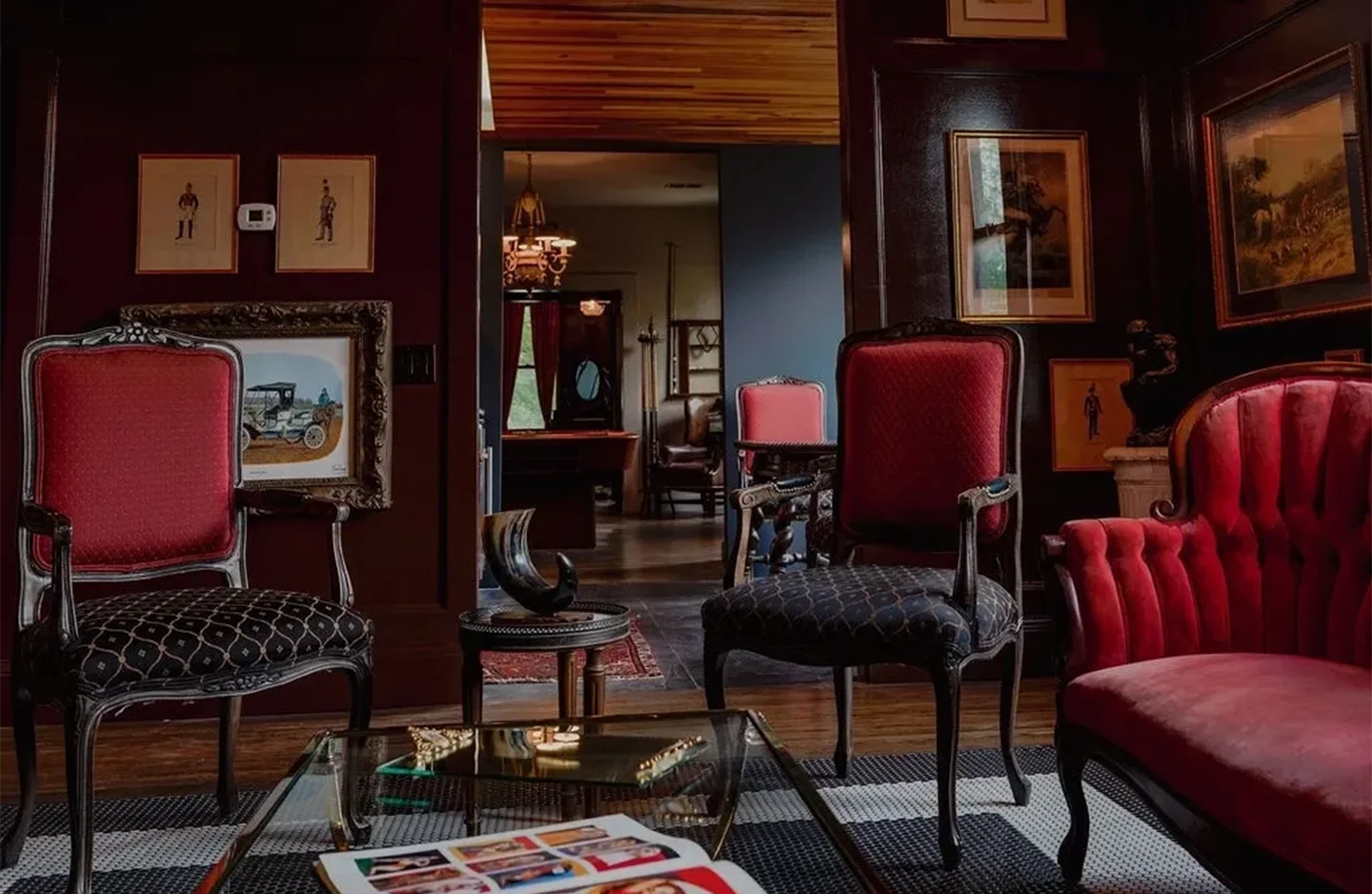 A living room with many chairs and paintings