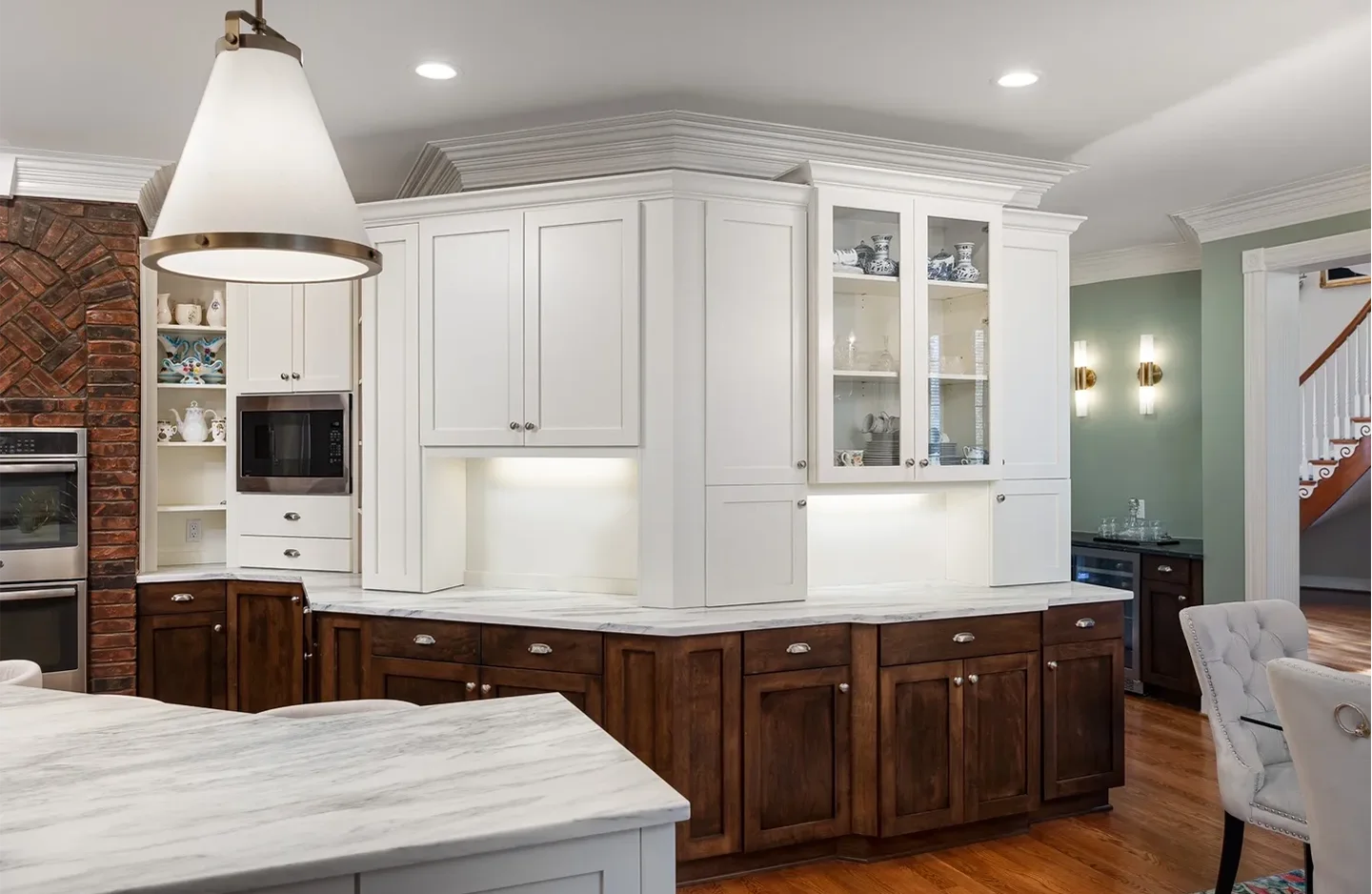 A kitchen with white cabinets and brown wood