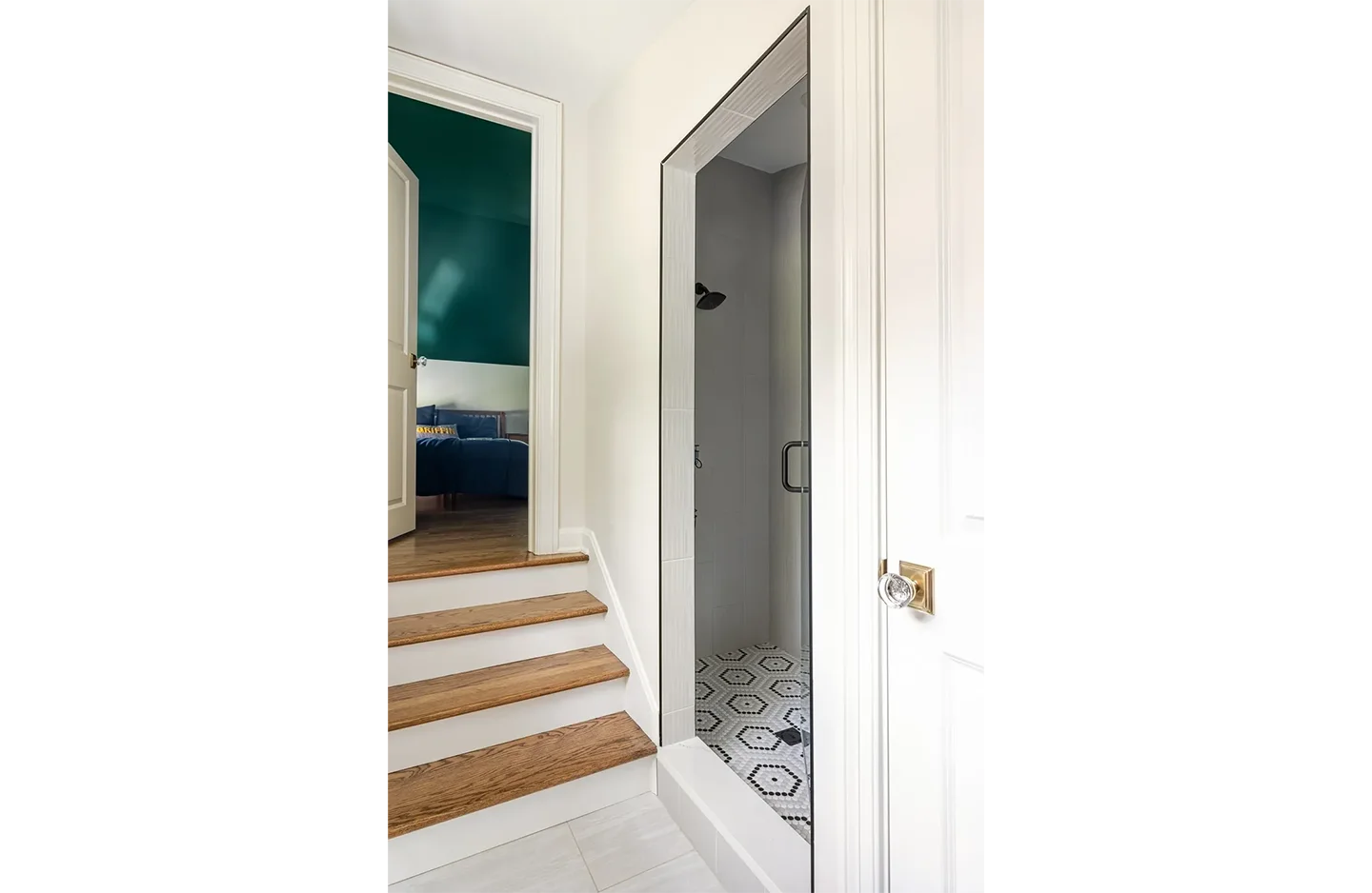 A bathroom with stairs and a door open.