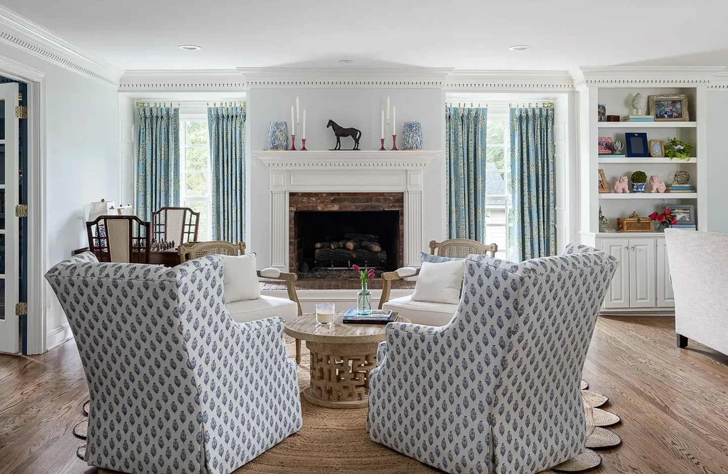 A living room with two chairs and a fireplace.