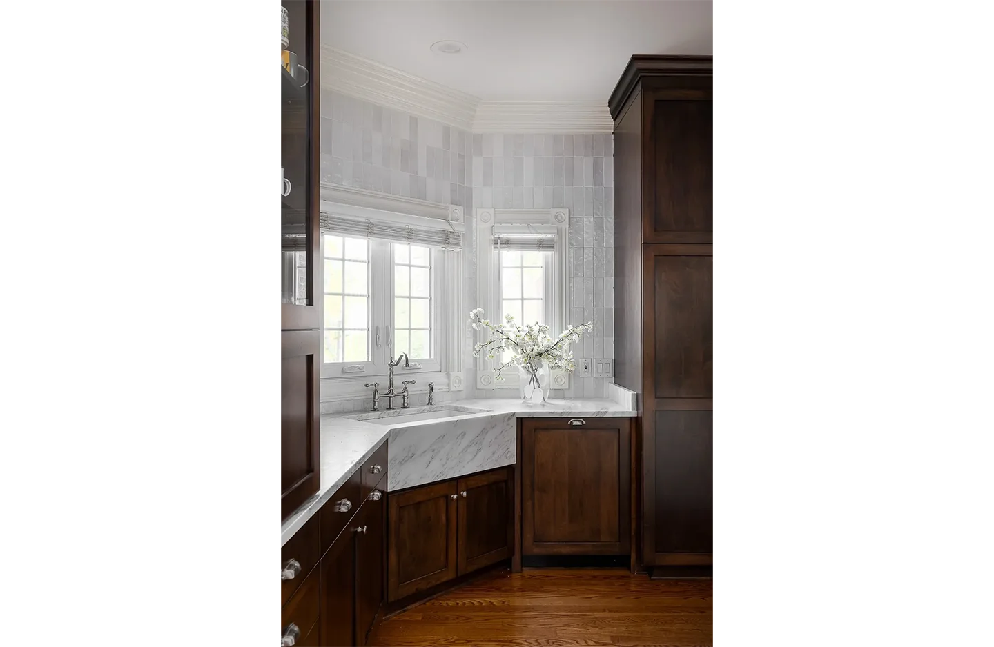 A kitchen with brown cabinets and white counter tops.