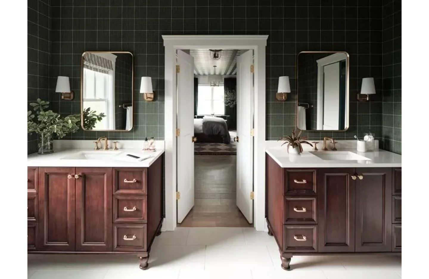 A bathroom with two sinks and mirrors in it