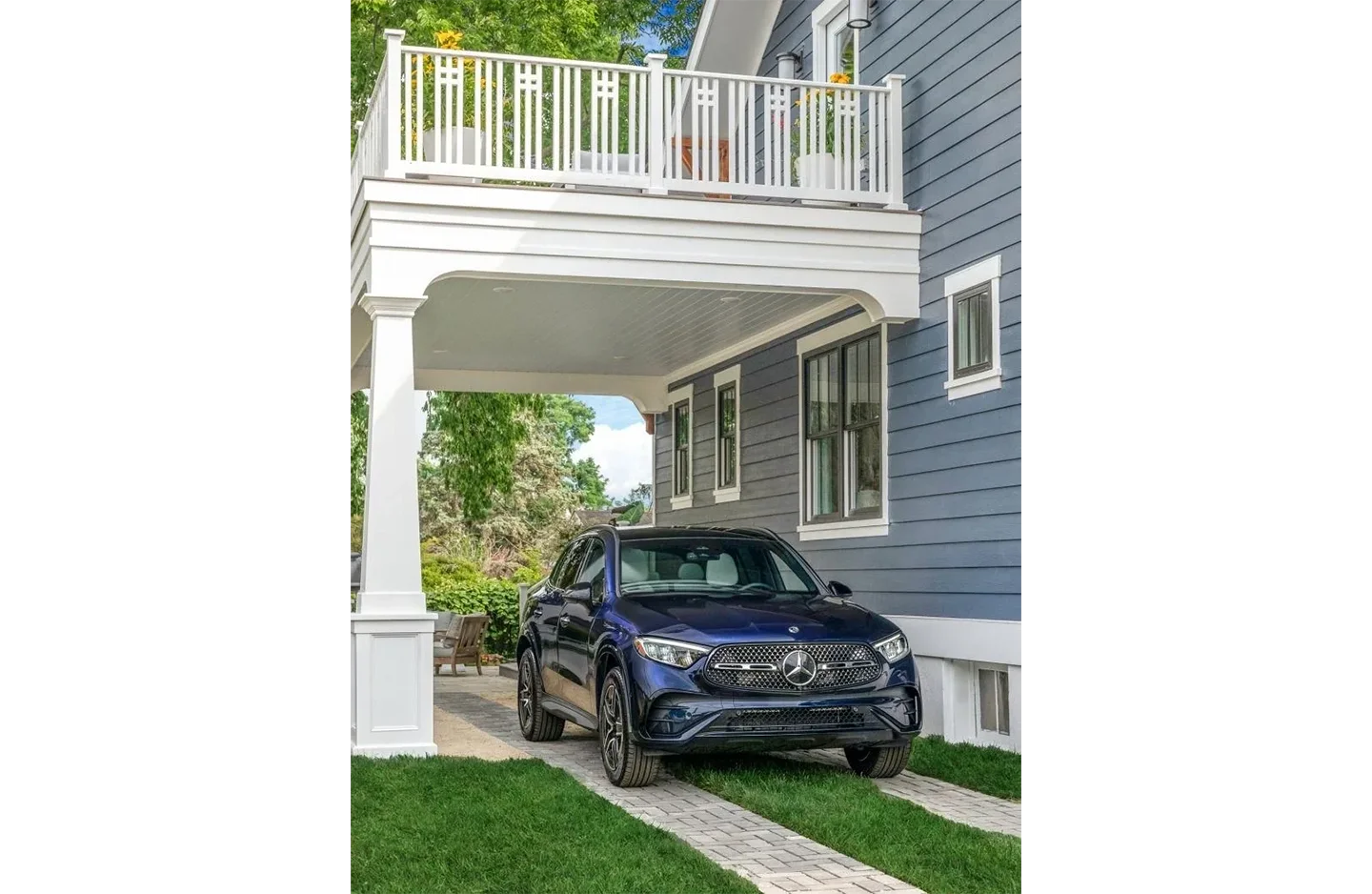 A car parked in the driveway of a house.