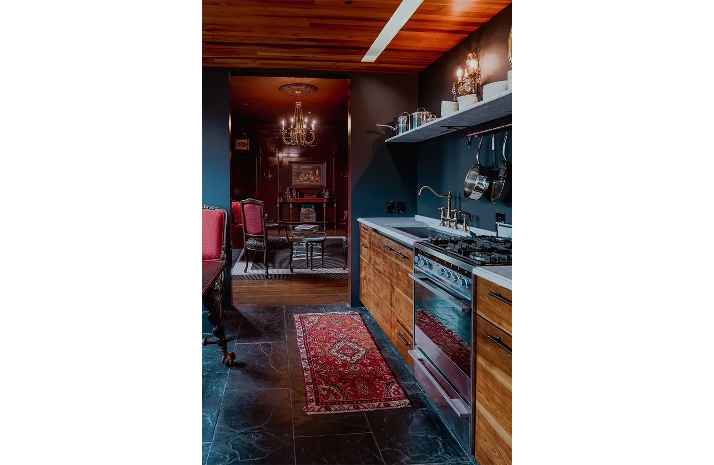 A kitchen with a rug and chairs in it