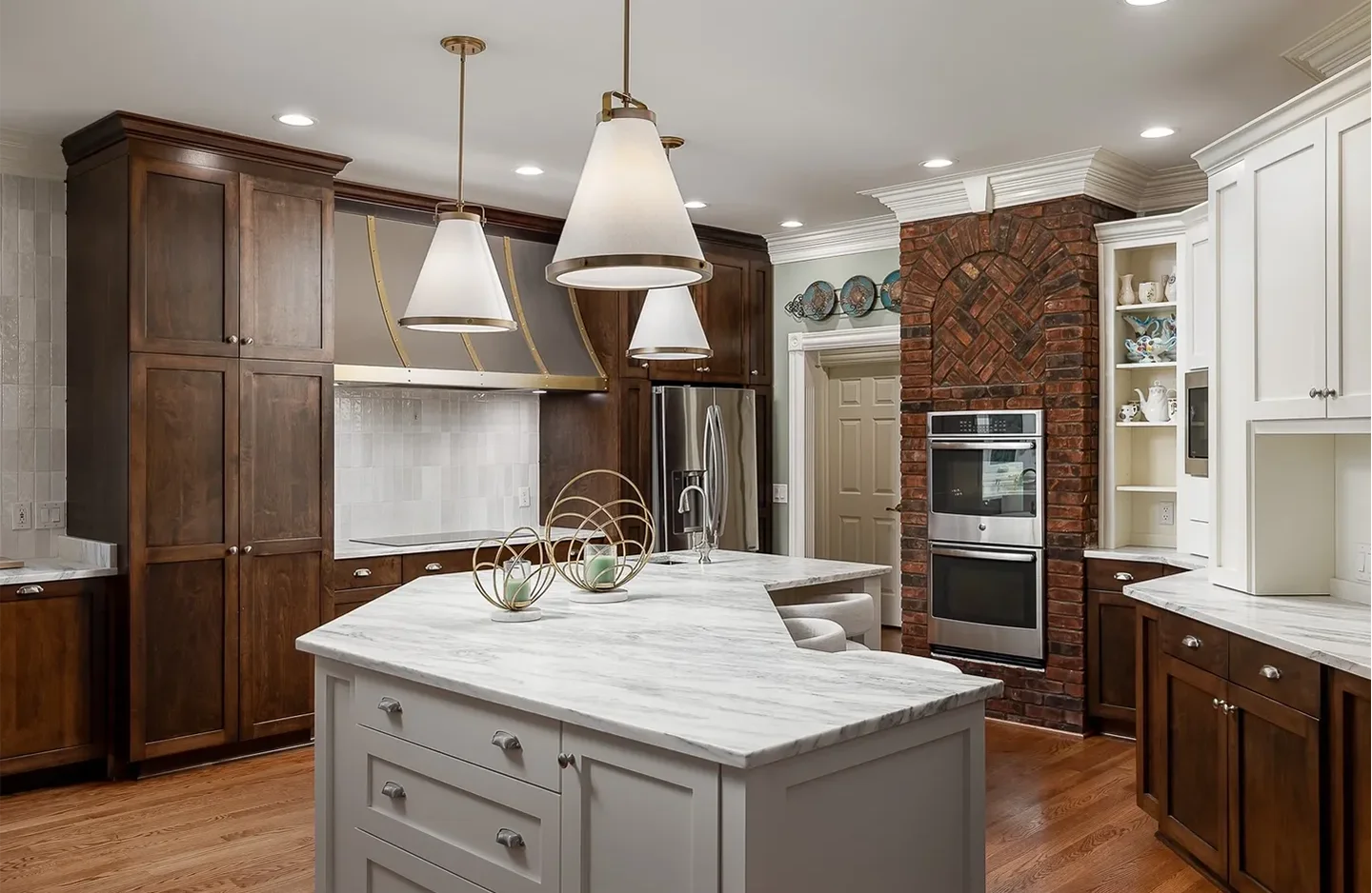 A kitchen with two large white marble counters.