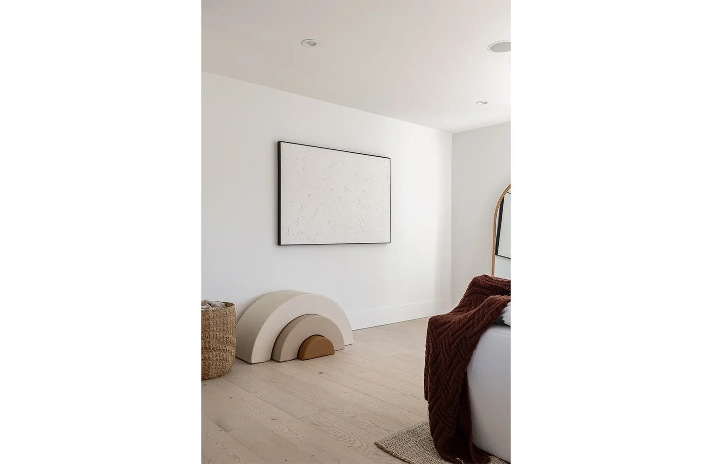 A room with a bed and a television on the wall.