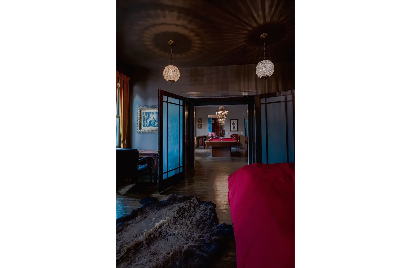 A red couch sitting in the middle of a room.