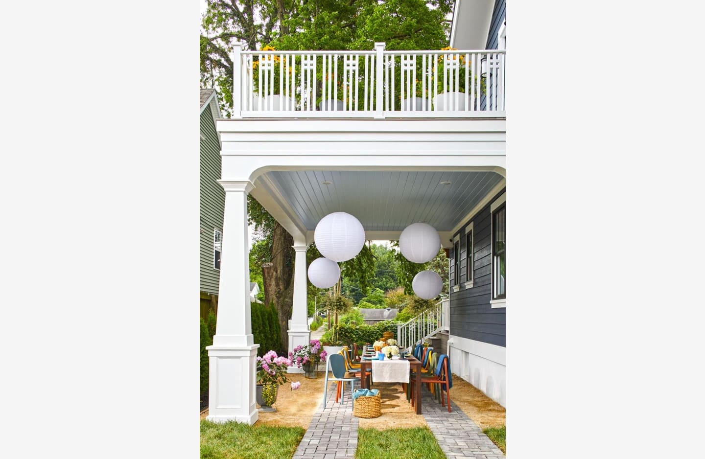 A porch with white balloons and a table