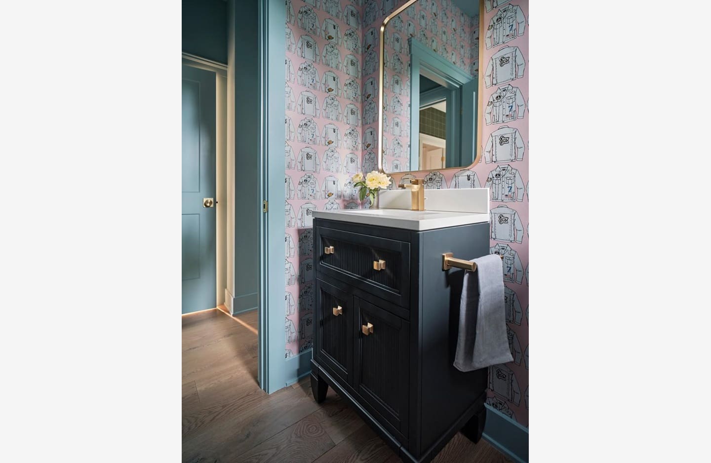 A bathroom with blue walls and a black cabinet.