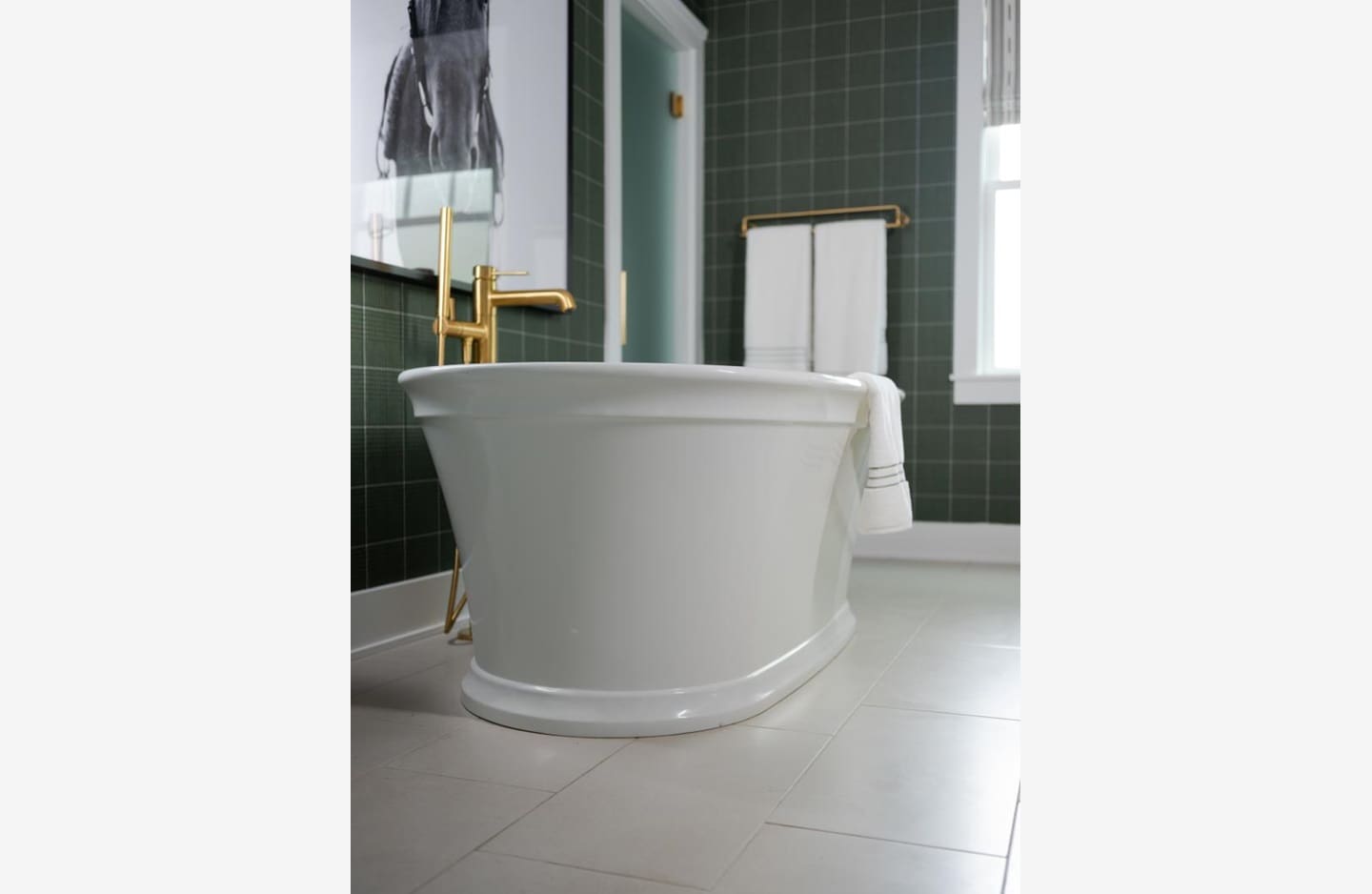 A white tub sitting in the middle of a bathroom.