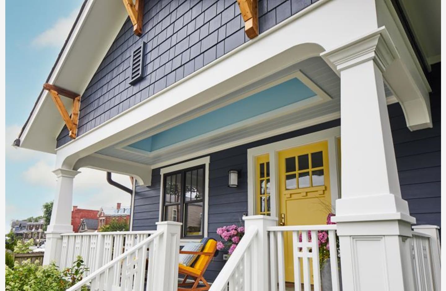 A house with blue and yellow trim is shown.