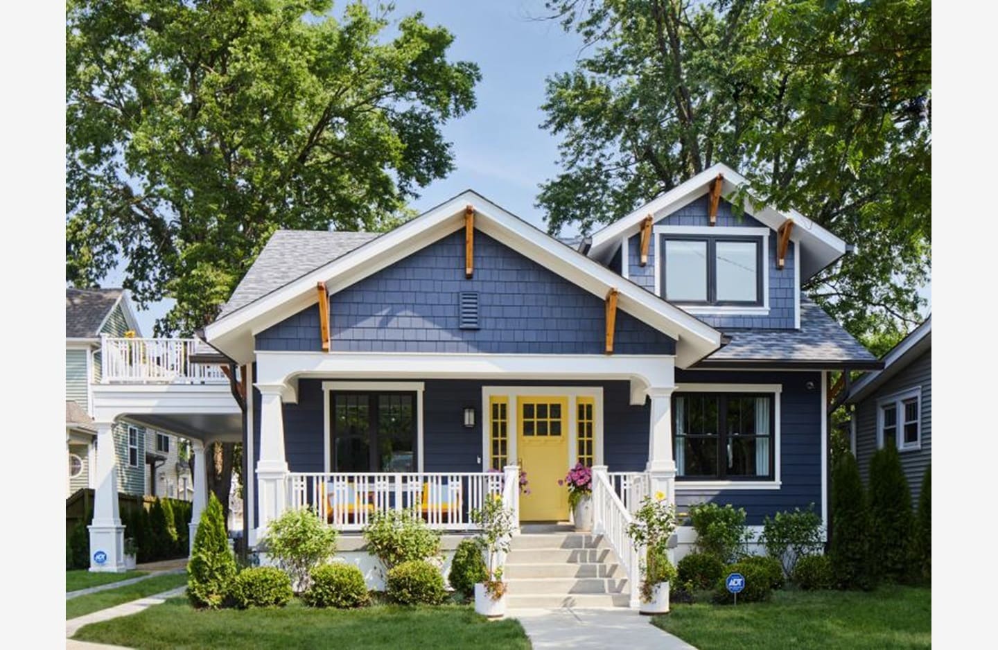 A blue house with yellow door and white trim.